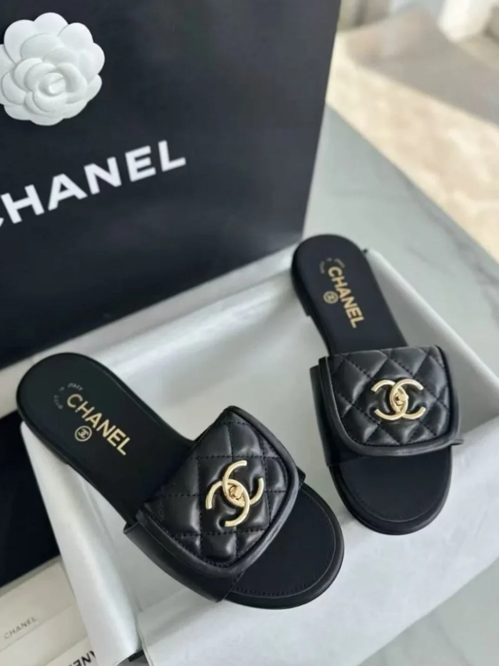 CHANEL Black Quilted Leather CC Turn‑Lock Flat Slide Sandals